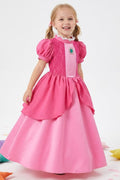 a little girl dressed up in princess peach costume dress, happy