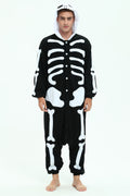 A man wearing a black and white skeleton-themed hooded onesie costume, standing against a plain white studio background.