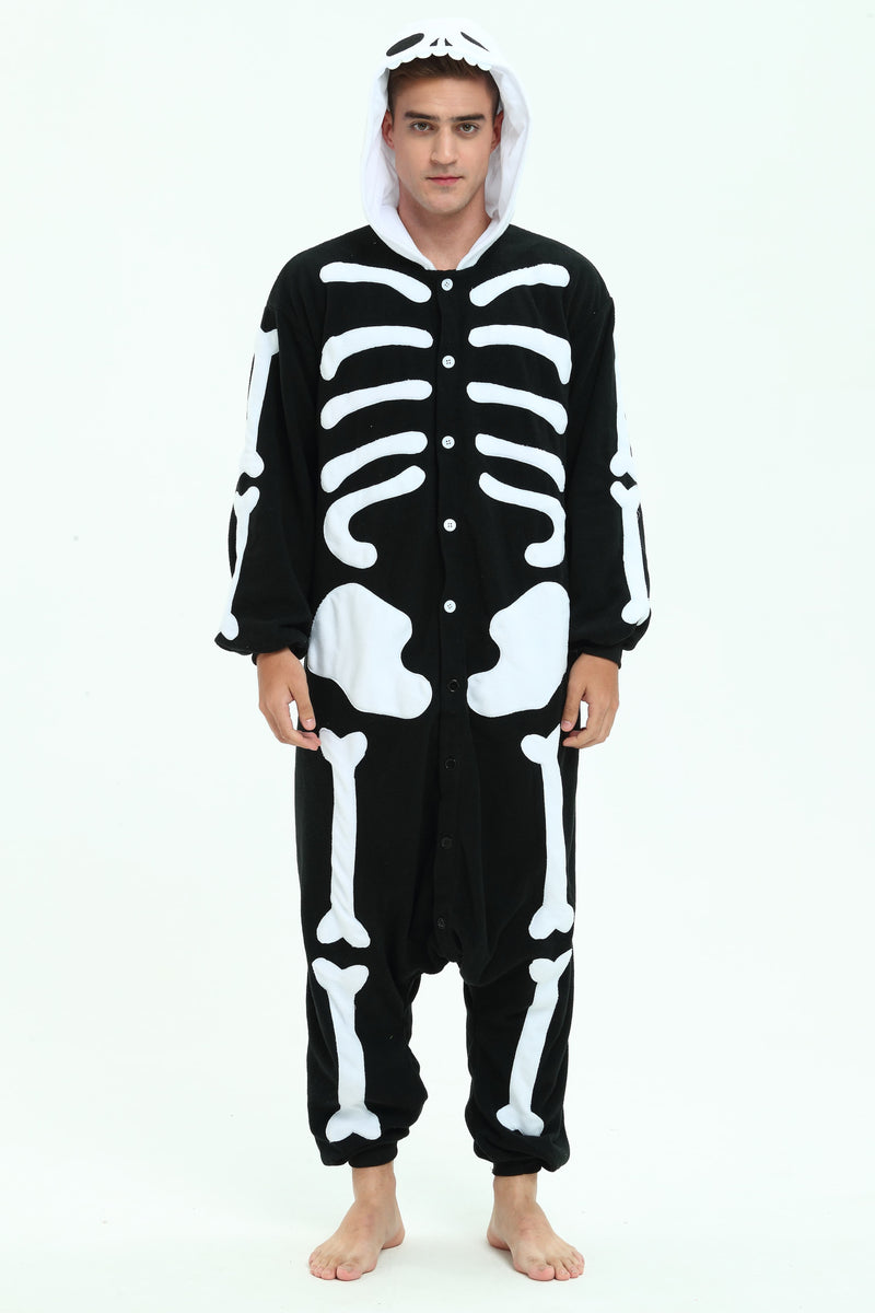 A man wearing a black and white skeleton-themed hooded onesie costume, standing against a plain white studio background.